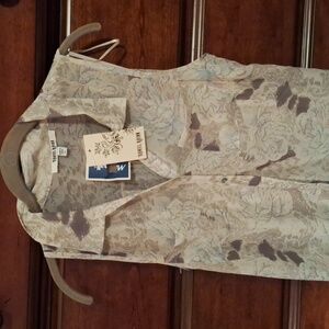 Sheer sleeveless blouse with beige shell.